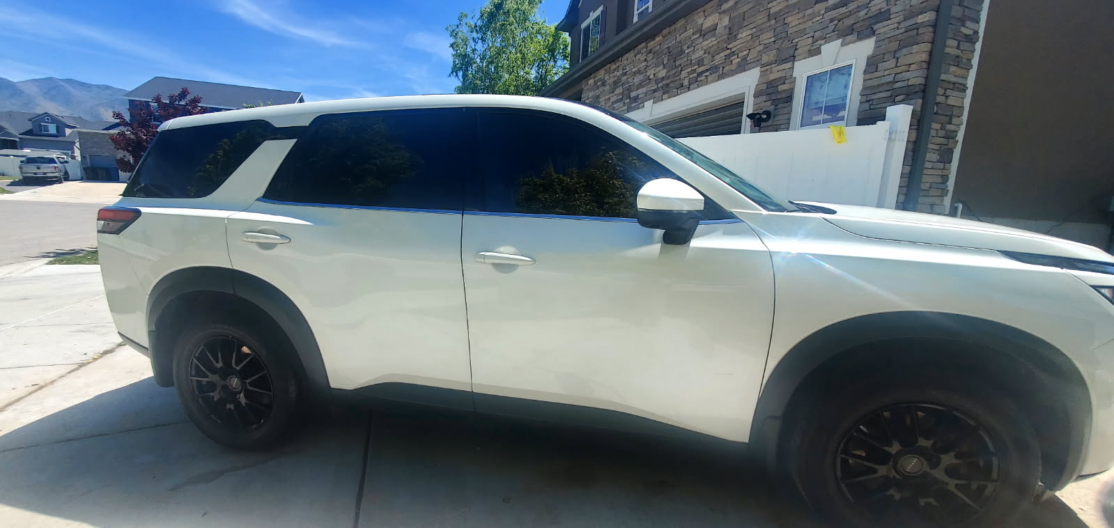 White Nissan Pathfinder SUV after wash — rear three-quarter view
